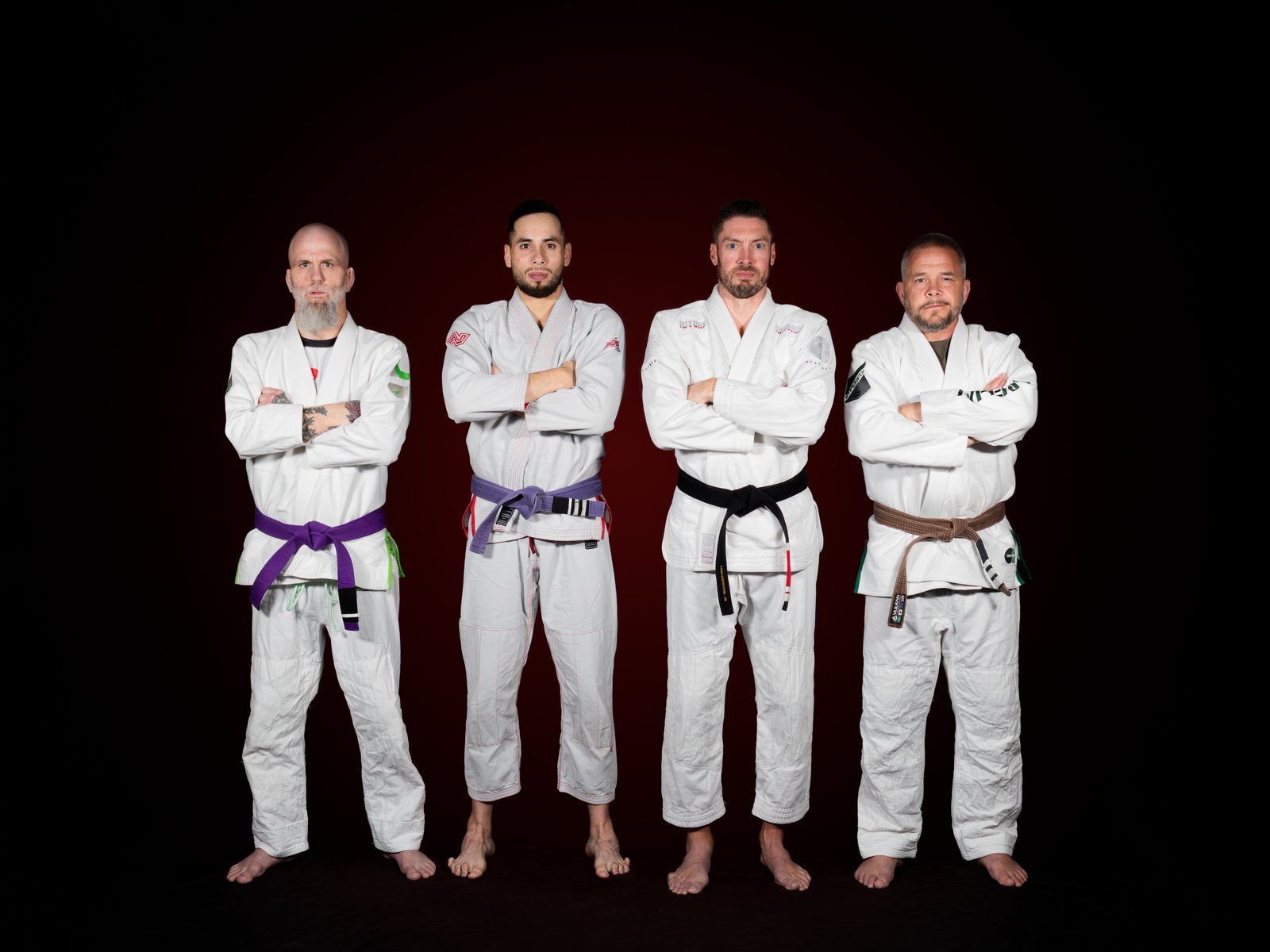 The Loyal Legion Jiu-Jitsu coaching staff together — Kevin Breeden, Neil Johnson, Mike Pendlebury, and Estefano Altamirano